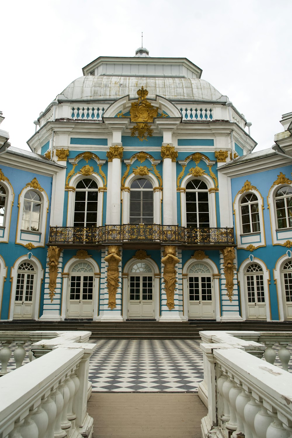 a large blue and white building with gold accents