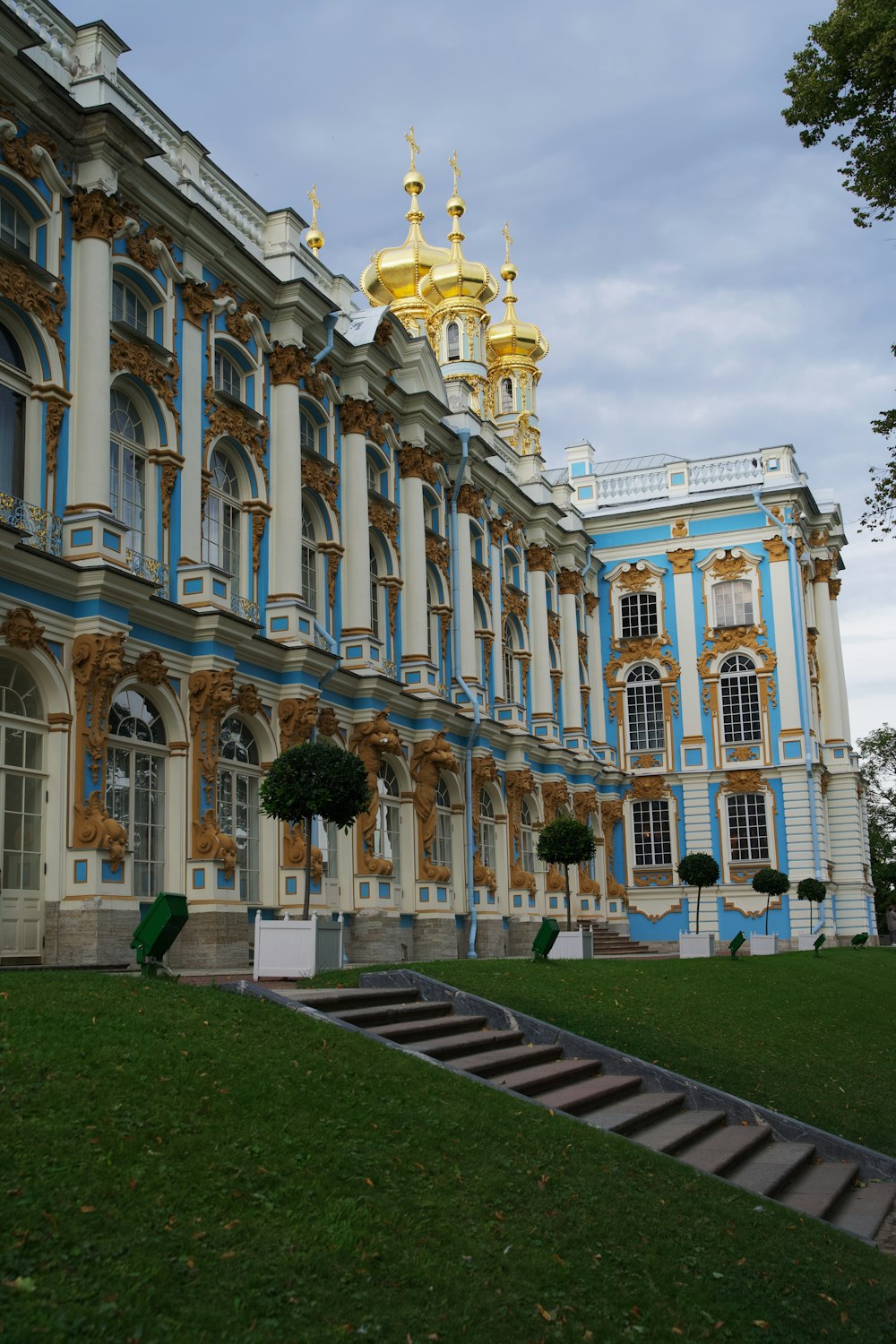 a large blue and white building with gold trim