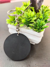 Close-up of a vintage key and houseplant on a rustic wooden table symbolizing property management.