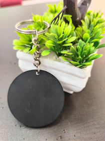 Close-up of a vintage key and houseplant on a rustic wooden table symbolizing property management.