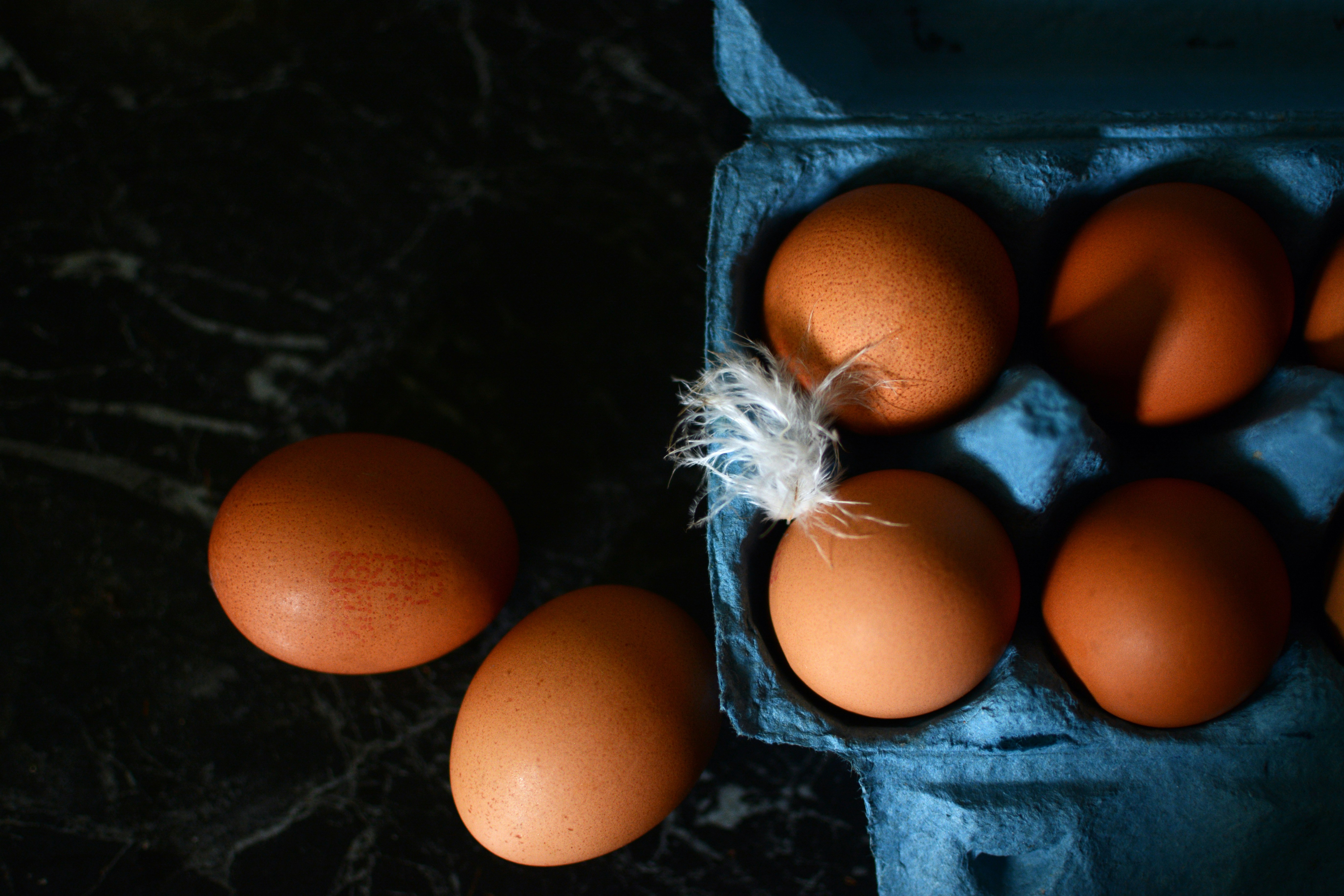 a bunch of eggs in a carton on a table