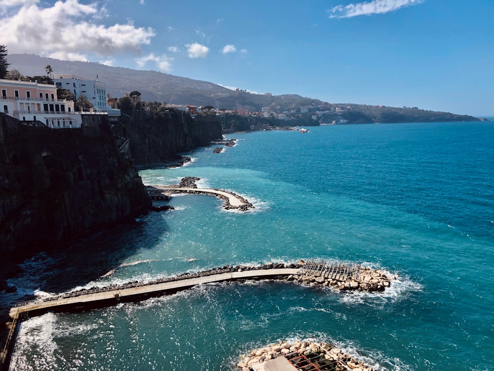 a body of water next to a cliff