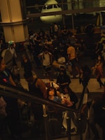 A scenic view of a bustling airport terminal with travelers and planes.