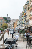 Lively European town street with colorful buildings and cafes
