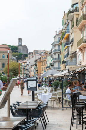 Lively European town street with colorful buildings and cafes