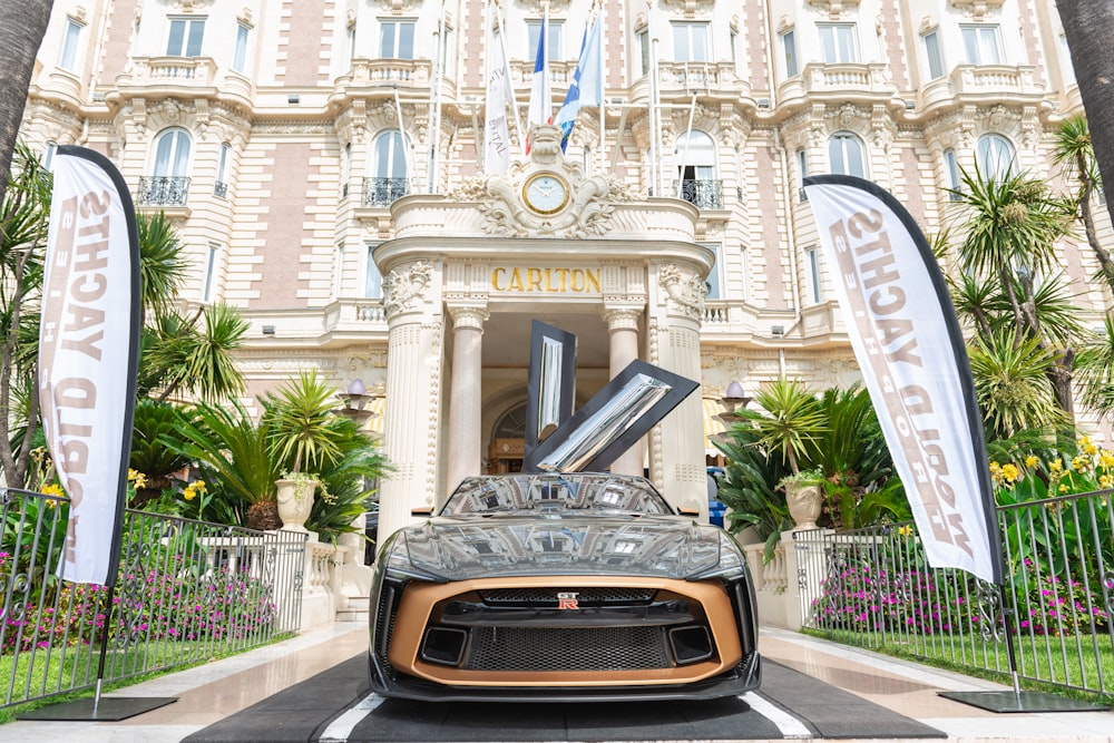 a sports car parked in front of a building