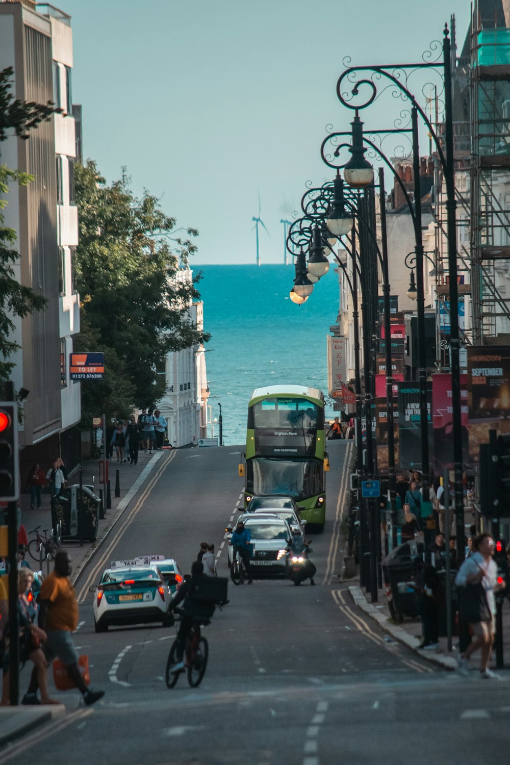 a city street with a bus, cars, and a bicycle