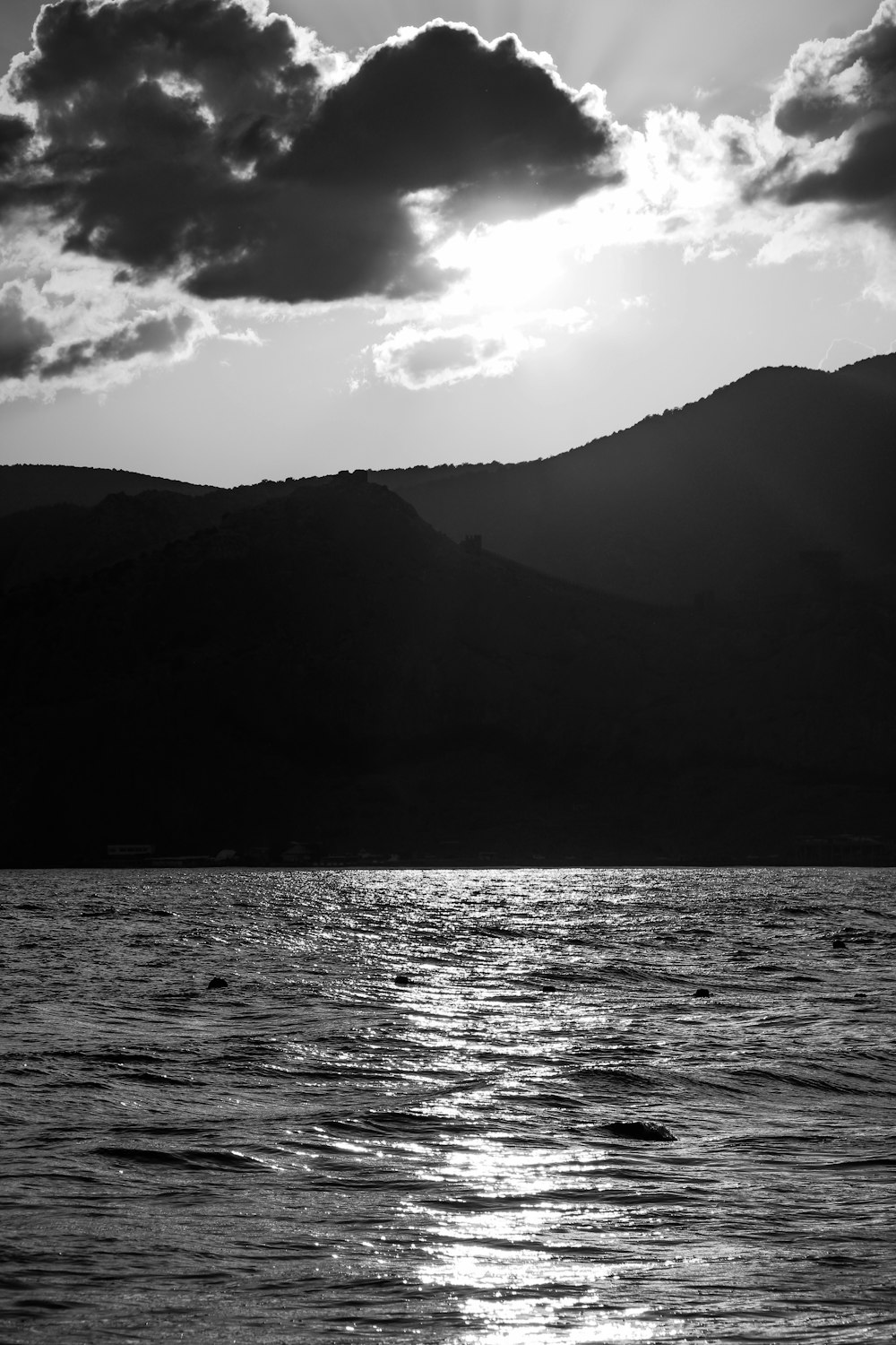 a large body of water under a cloudy sky