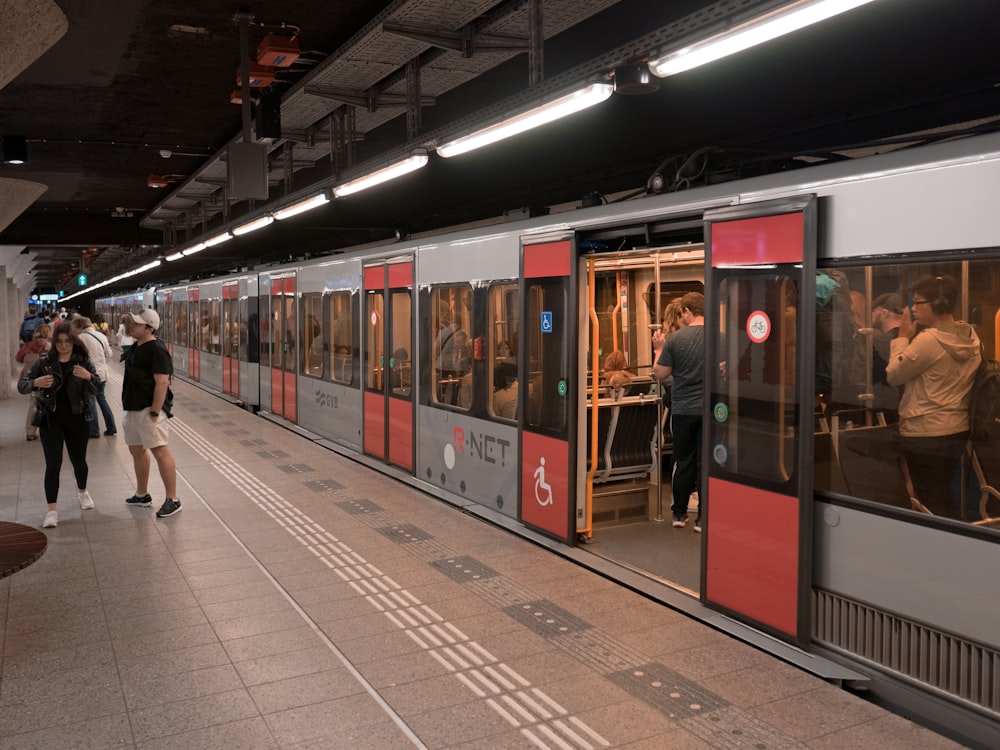 電車の横に立つ人々のグループ