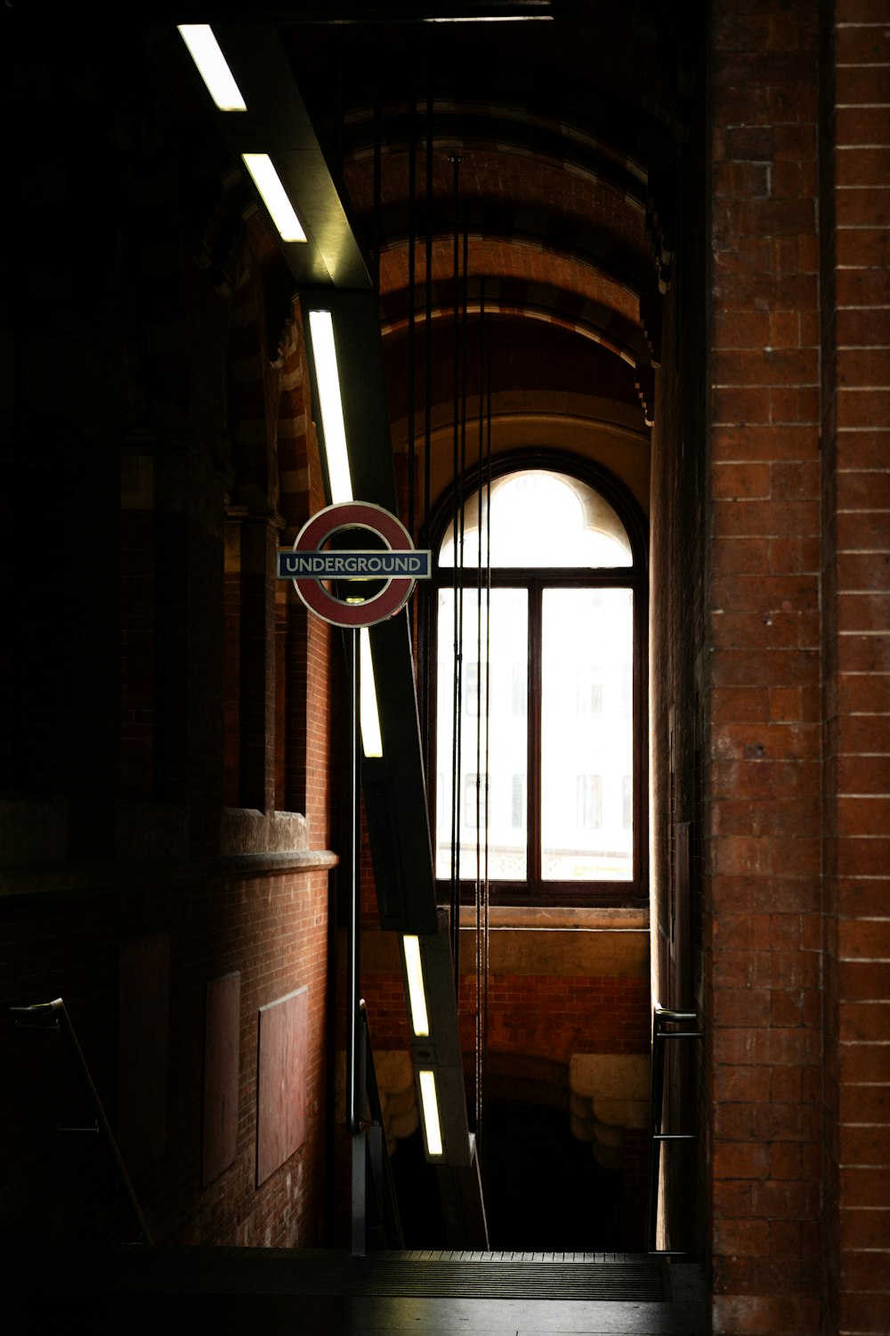 a sign hanging from the side of a brick building