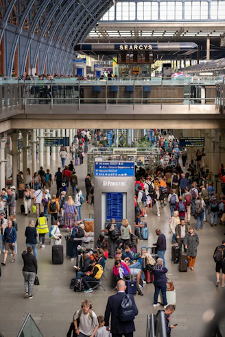 a large group of people with luggage at an airport