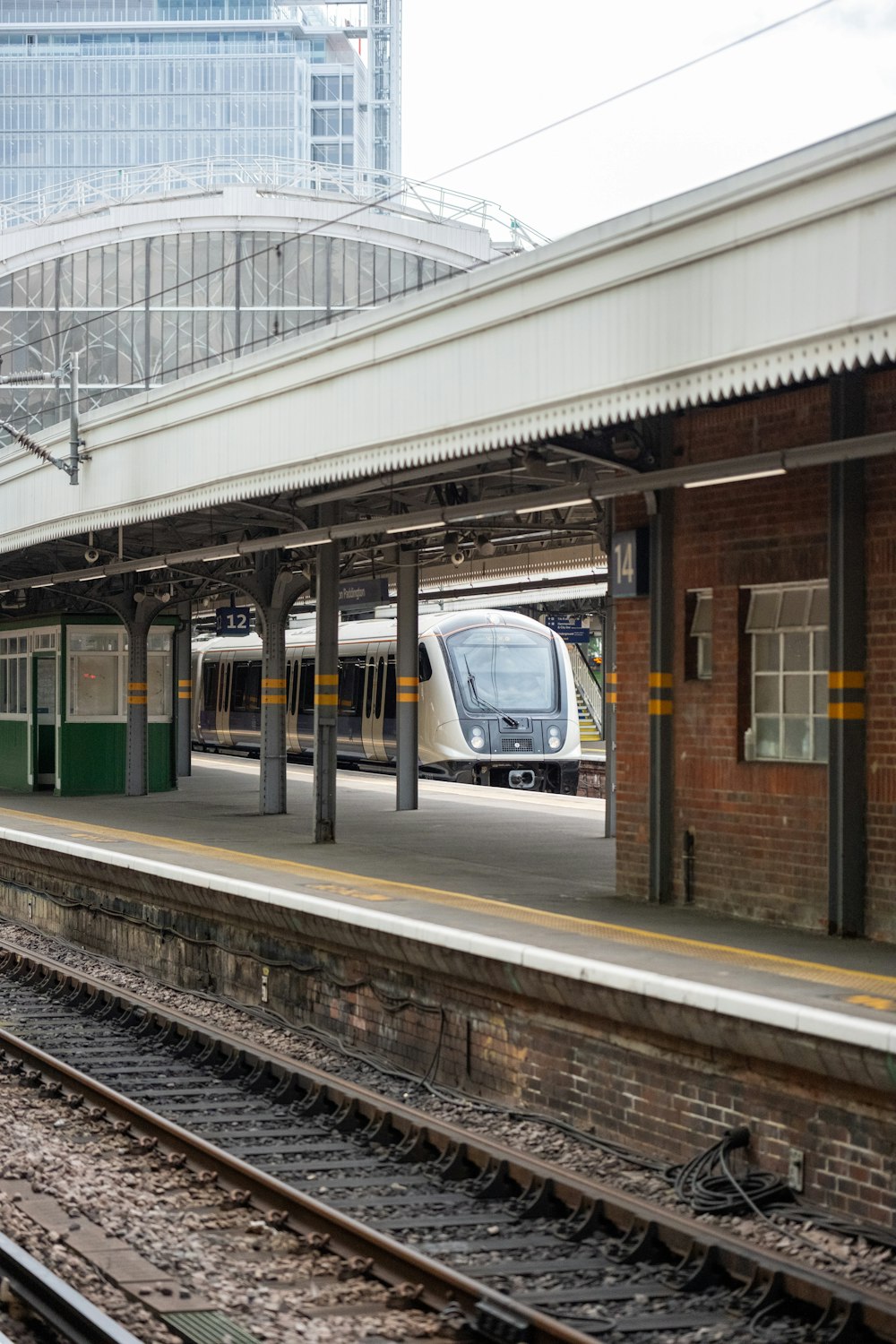 a train pulling into a train station next to a platform