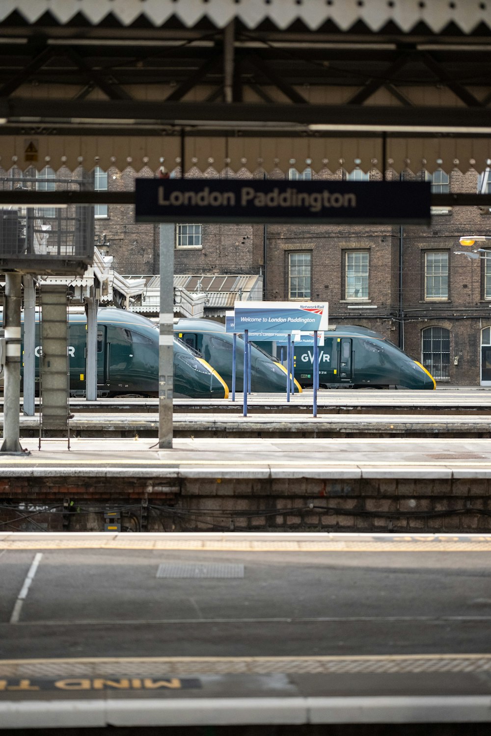 a train station with two trains on the tracks