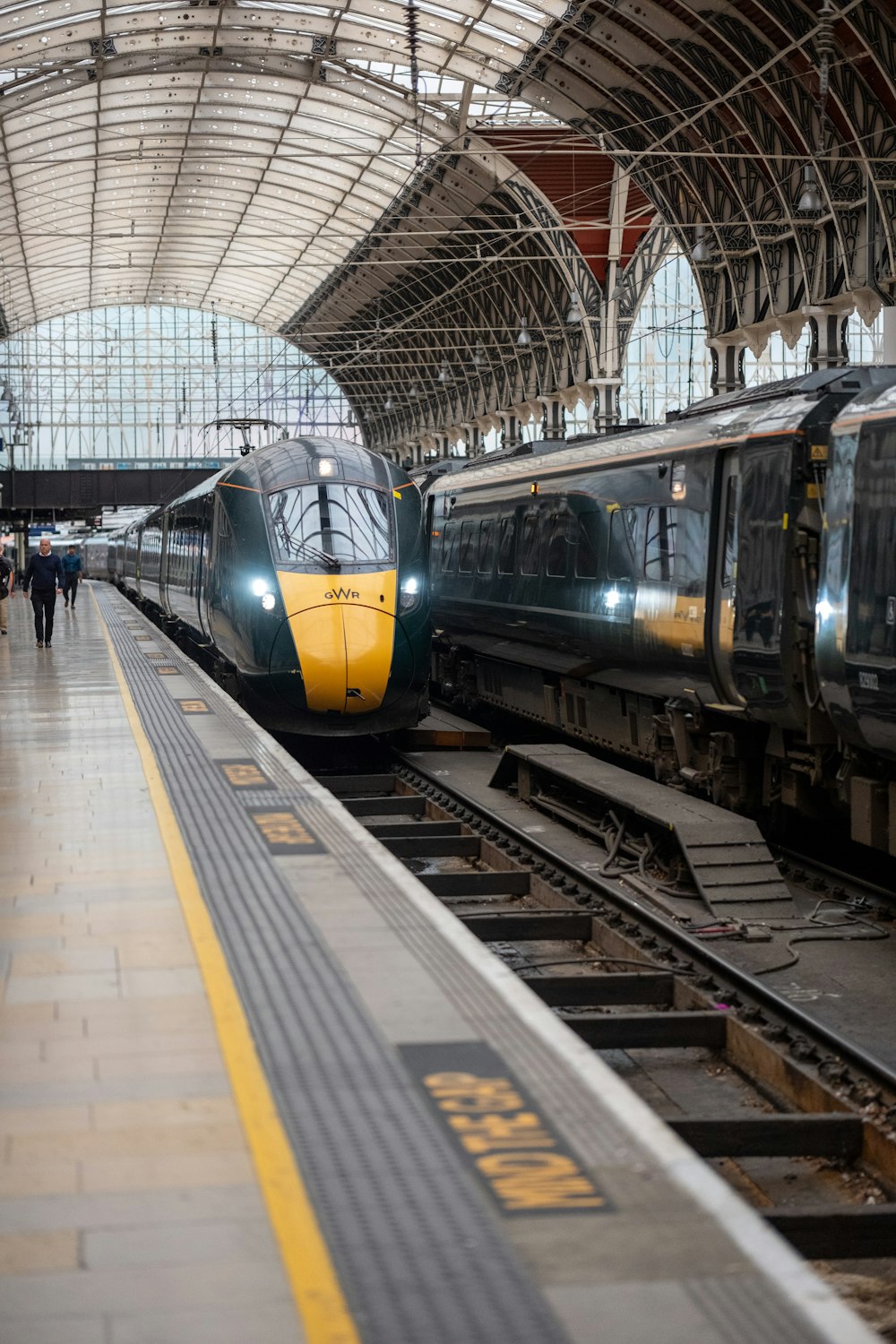 a couple of trains that are sitting in a station