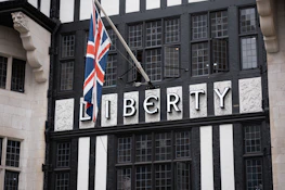 a black and white building with a flag on top of it