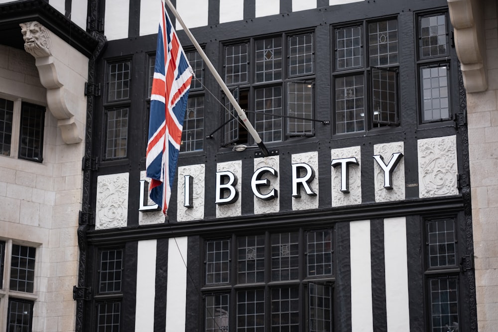 a black and white building with a flag on top of it