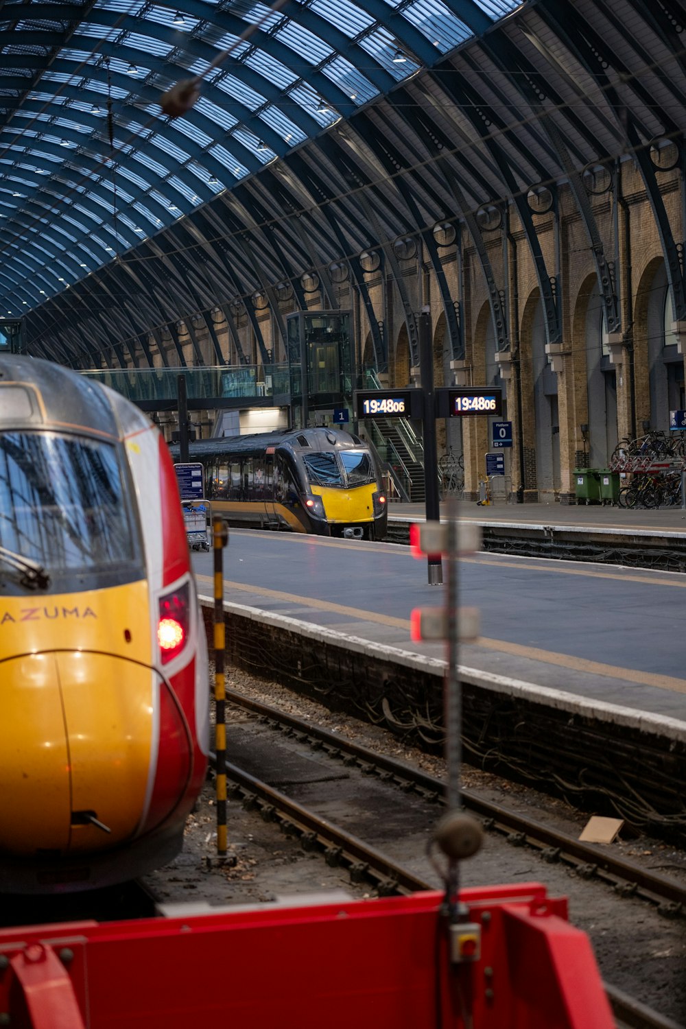 a yellow and silver train traveling down train tracks