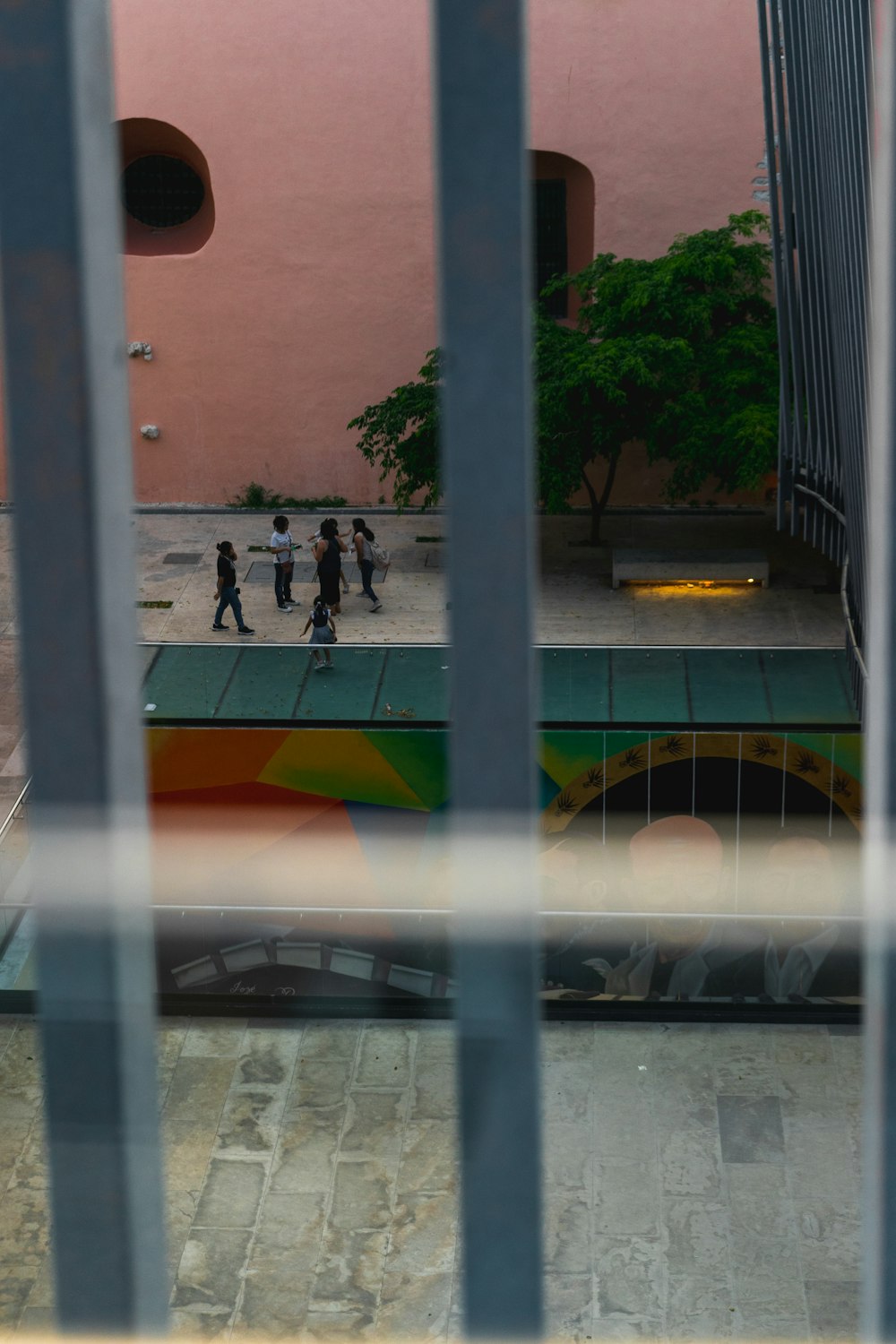 a group of people walking down a street next to a tall building