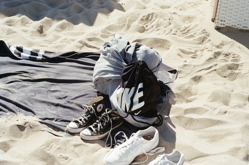 a pair of sneakers and a towel on a beach