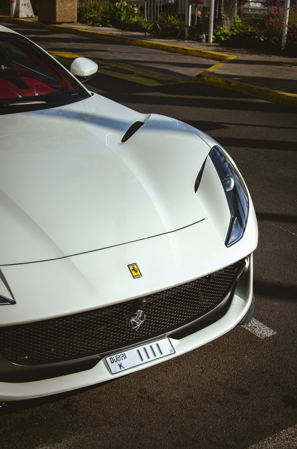 a white sports car parked in a parking lot