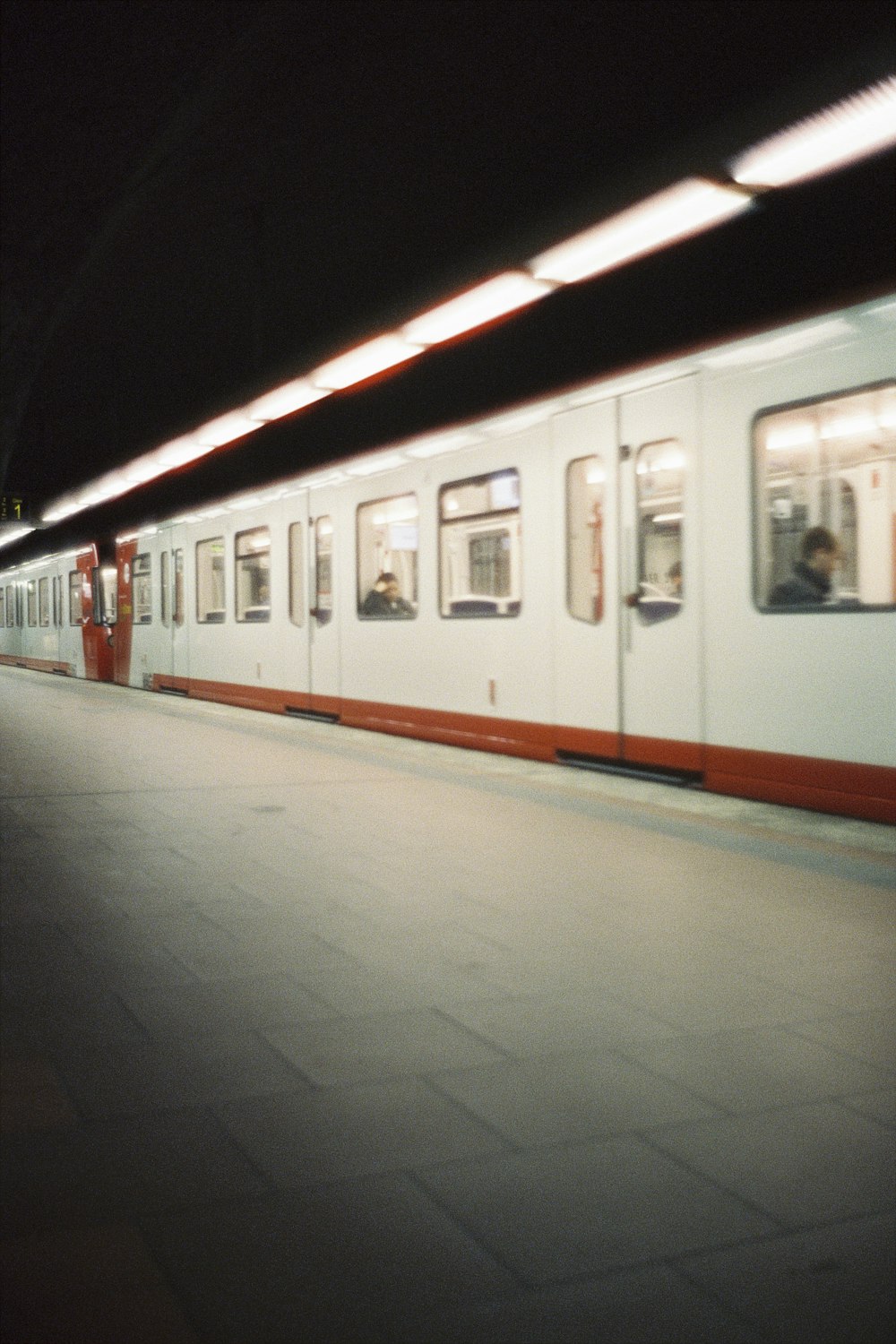 a subway train traveling down train tracks at night