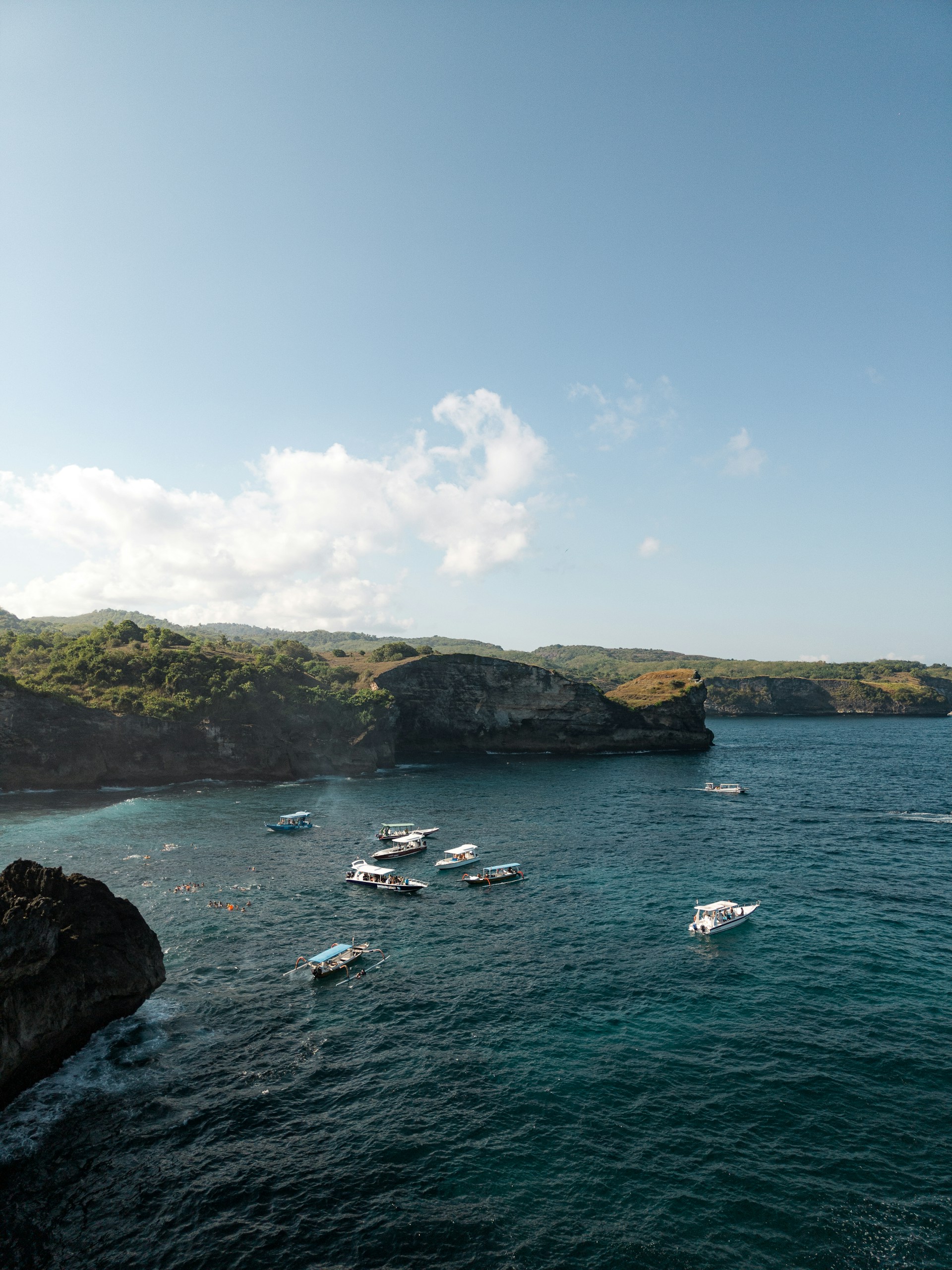 a group of boats floating on top of a body of water