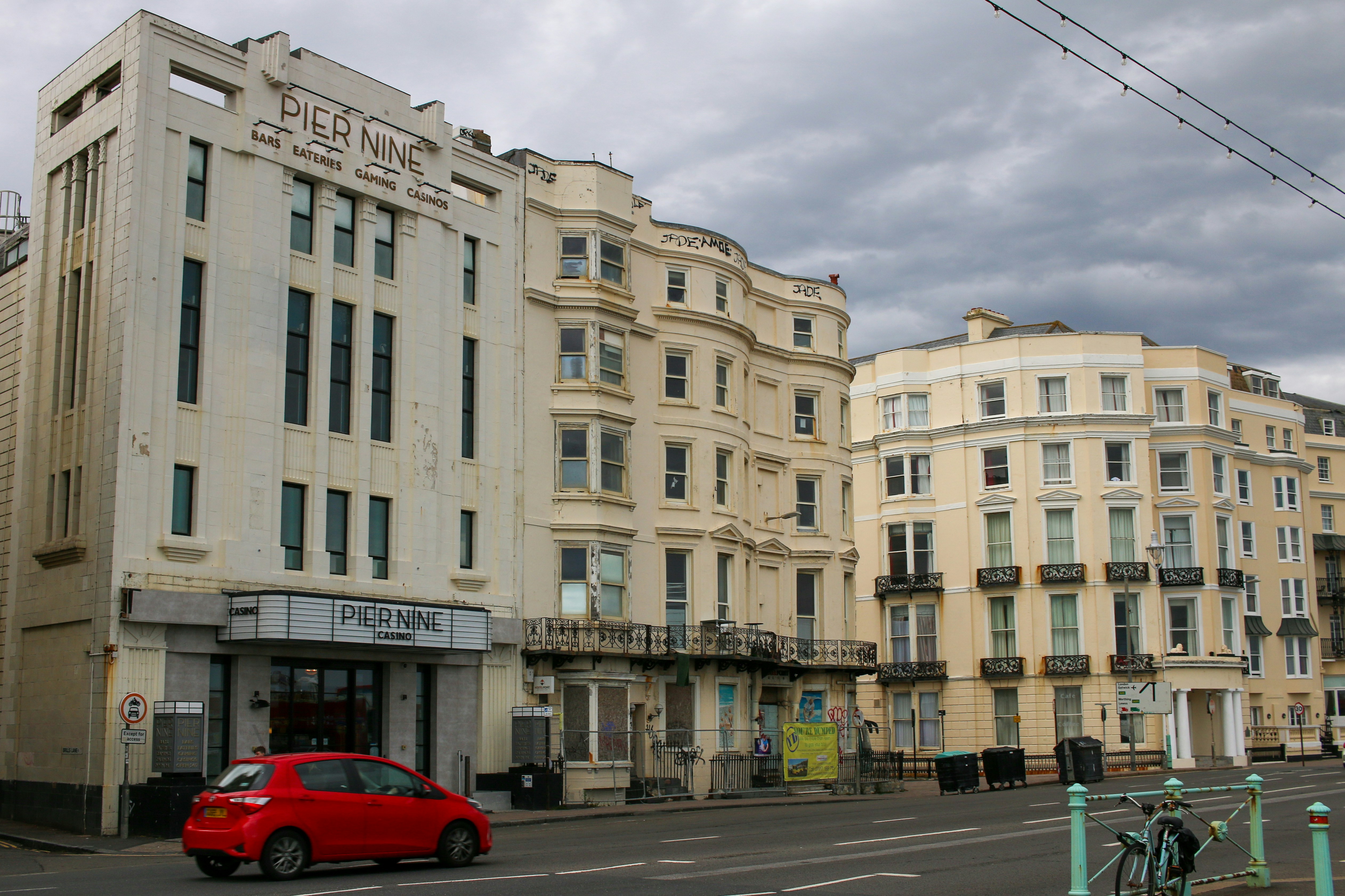 a red car parked in front of a building