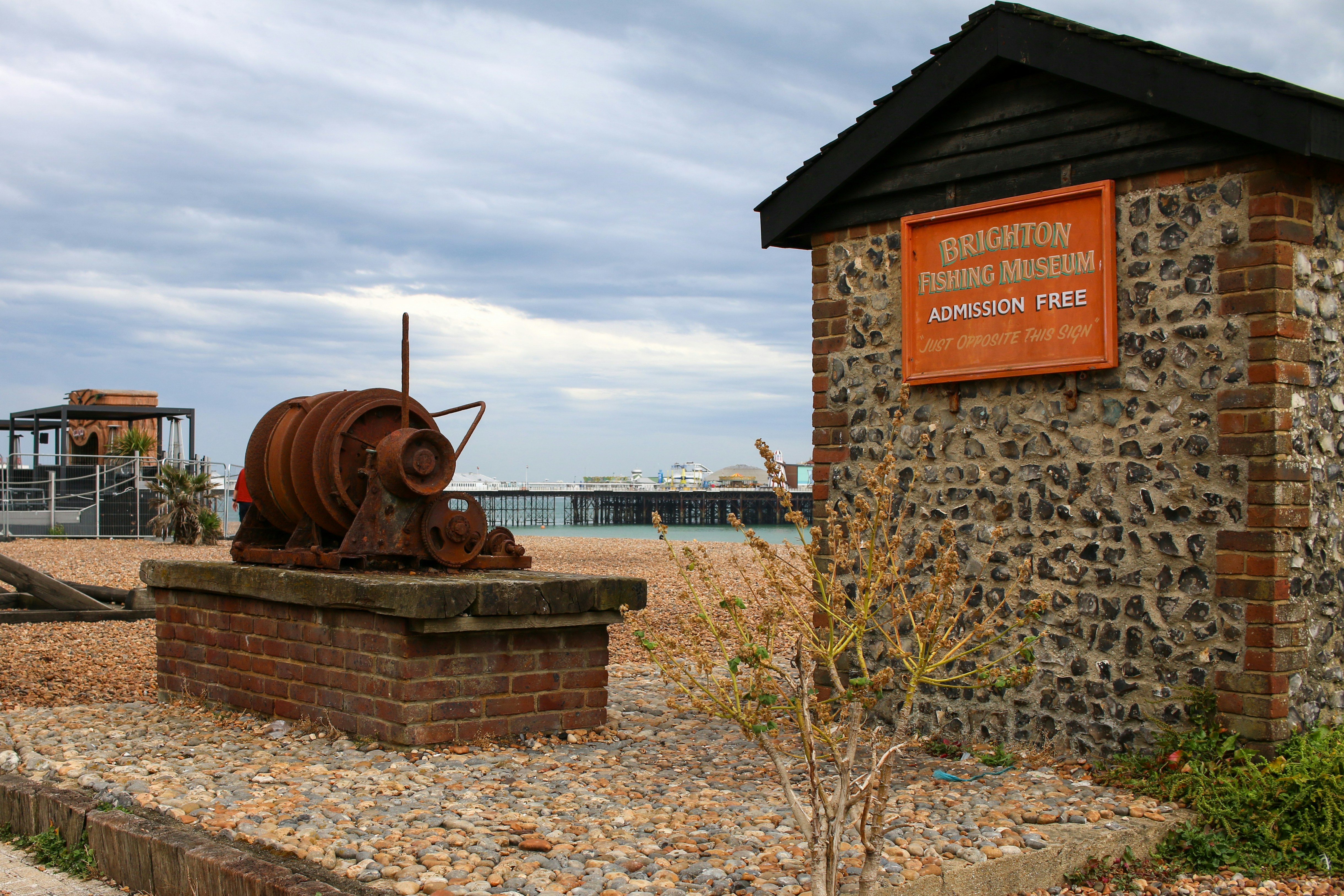 a large rusted metal object sitting on top of a brick wall