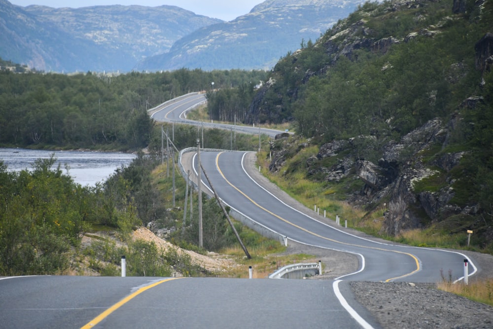 a curved road in the middle of a mountain range