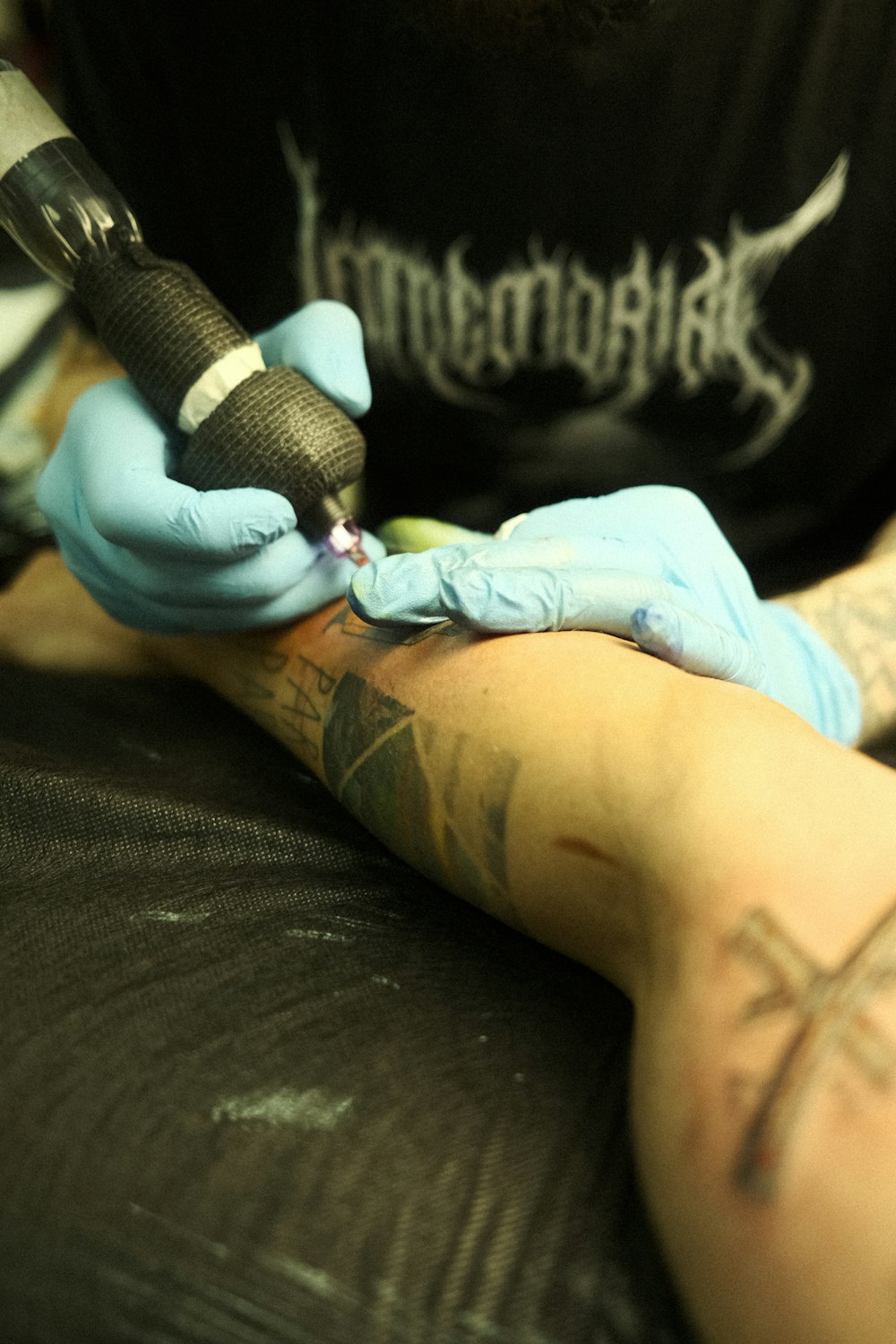 a man getting a tattoo done on his arm