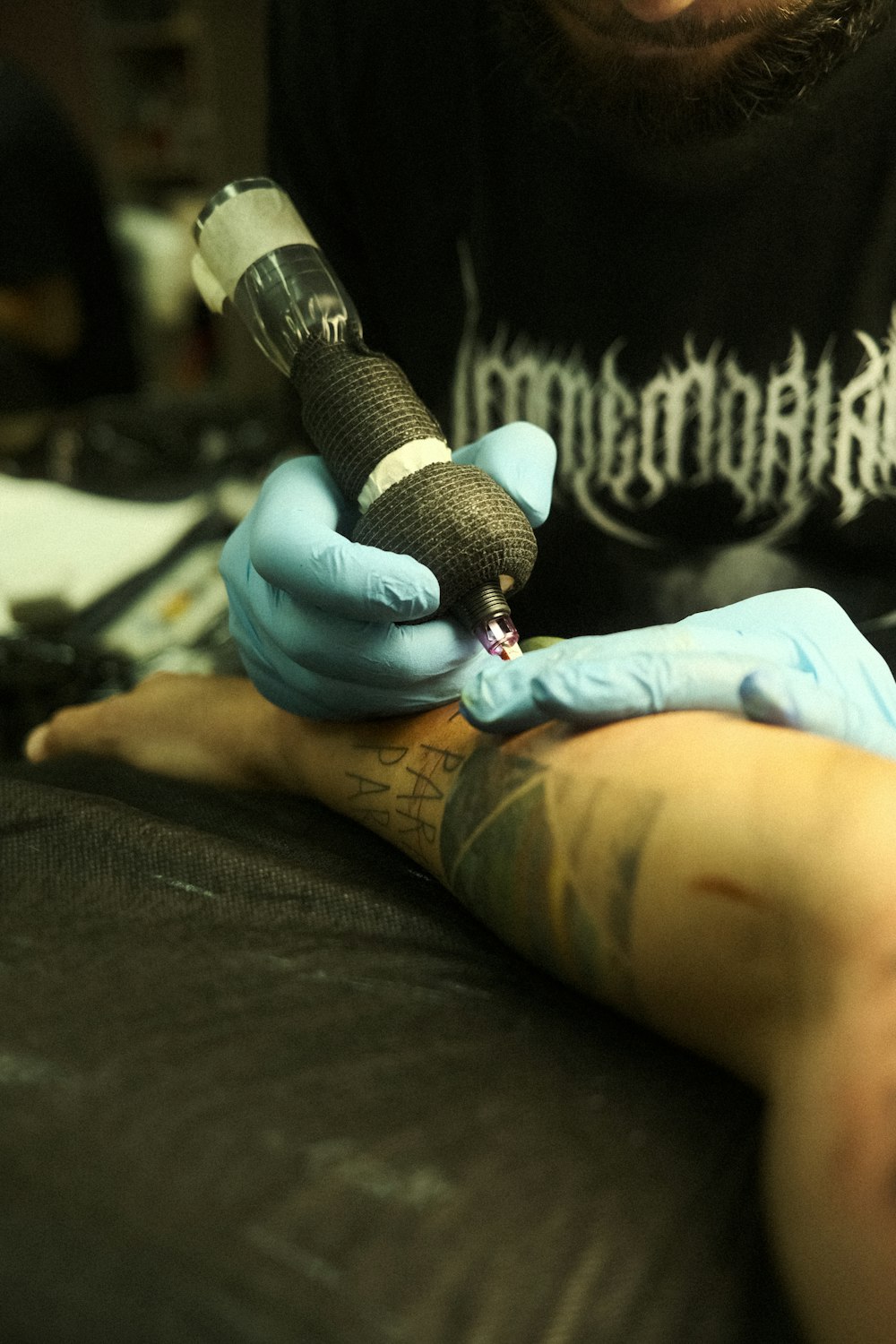 a man getting a tattoo done on his arm