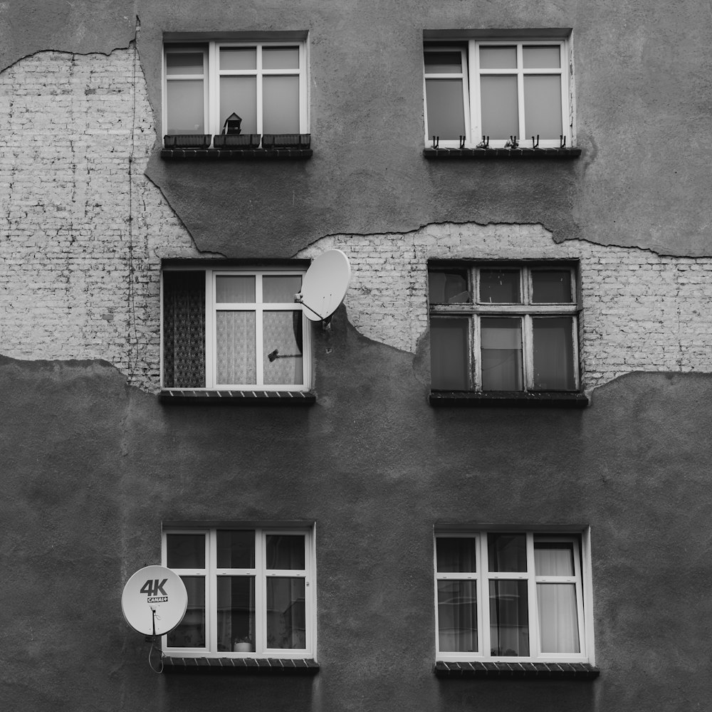 a black and white photo of a building with broken windows