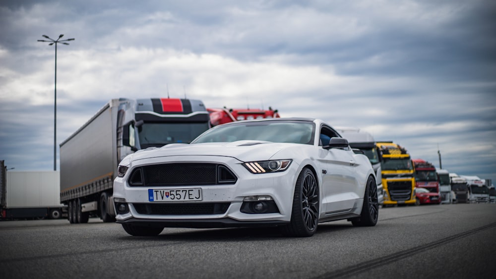 a white ford mustang parked in a parking lot