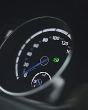 Close-up of a plug-in hybrid car dashboard with eco-friendly indicators.