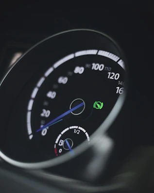 Close-up of a hybrid car dashboard with eco-friendly indicators lit up.