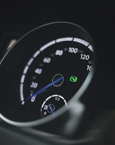 Close-up of a hybrid car dashboard displaying eco-friendly driving stats.