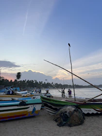 Sunset view over the scenic coastline of Tanza, with fishermen preparing their boats.