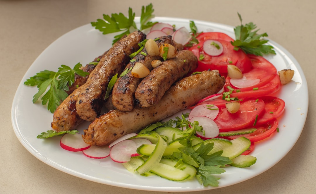 a white plate topped with meat and veggies