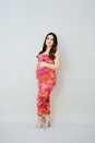 a pregnant woman in a pink and orange dress