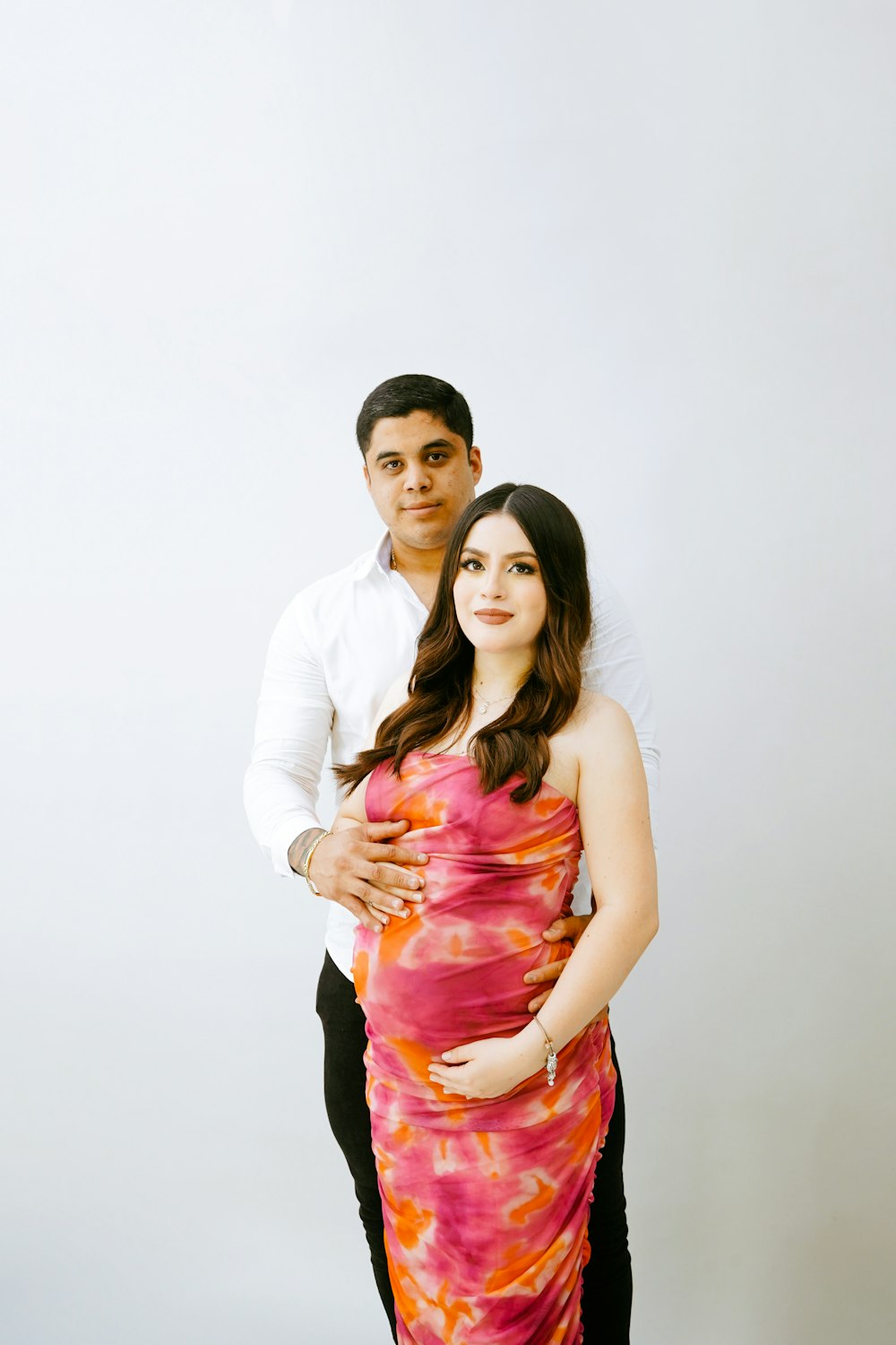 a pregnant couple posing for a picture