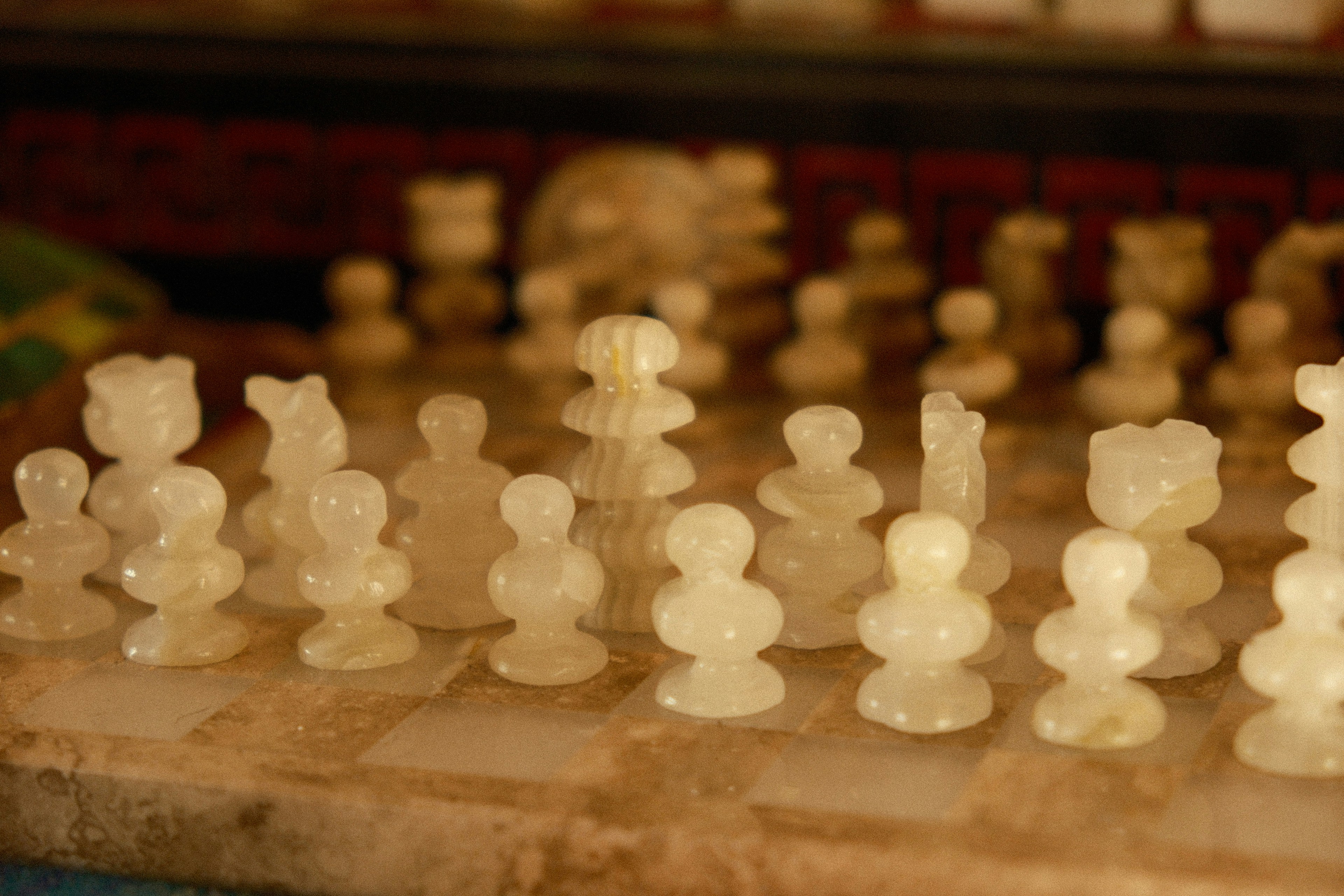 a close up of a chess board with pieces on it