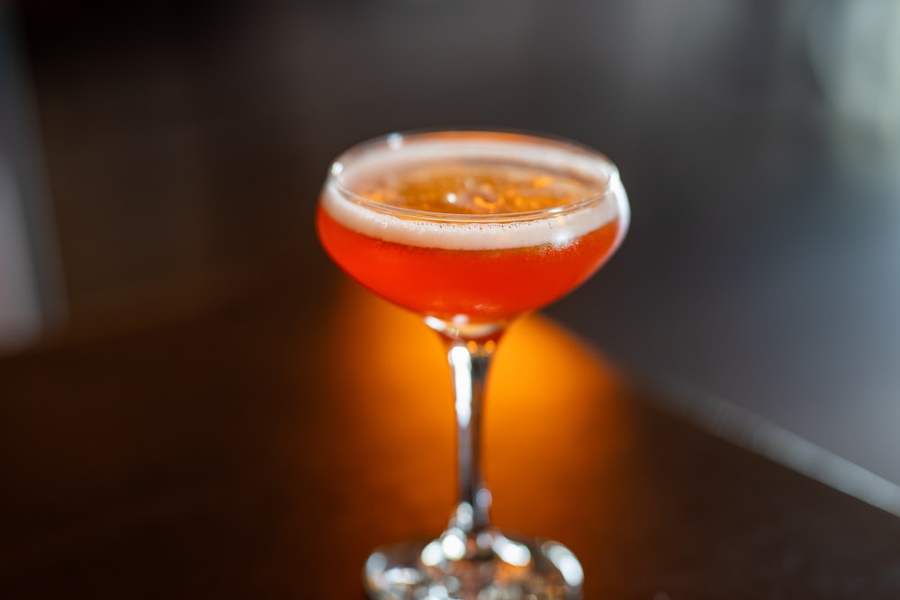 a close up of a drink in a glass on a table