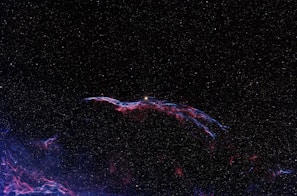 A cosmic landscape filled with stars and galaxies, representing the vastness of space.