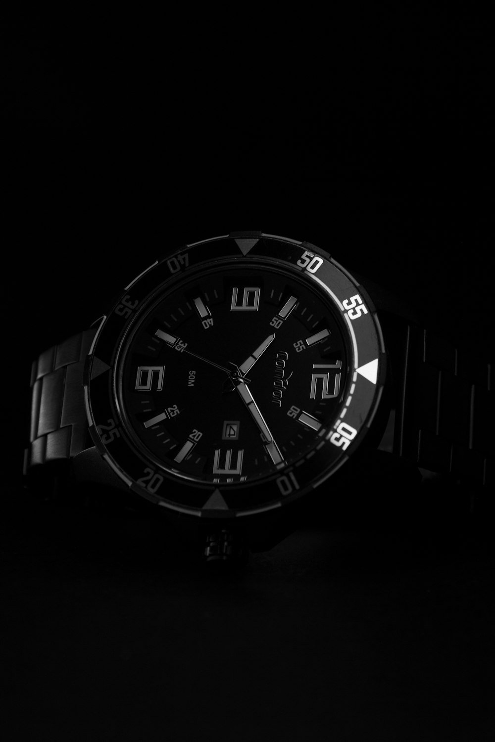 a watch sitting on top of a black table