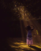 A serene scene showing a person wearing a faith-based shirt, standing in a sunlit garden.