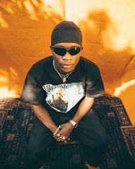 A stylish snap of accessories including snapback caps and layered chains, set against a dark, textured backdrop.