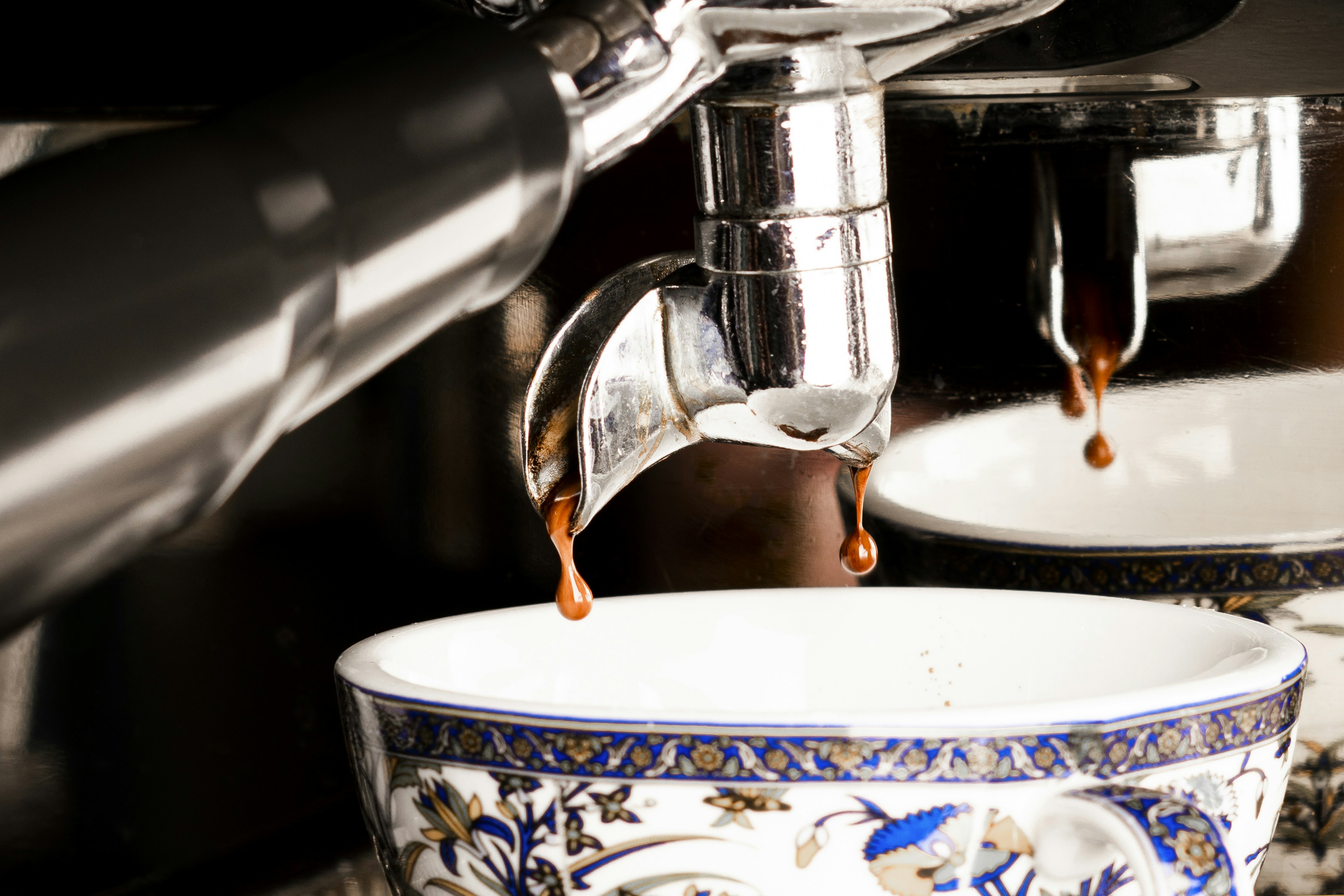 a coffee machine pouring coffee into a bowl