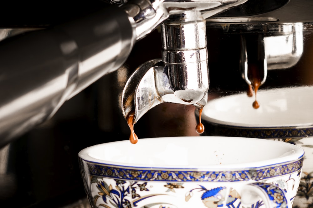 a coffee machine pouring coffee into a bowl