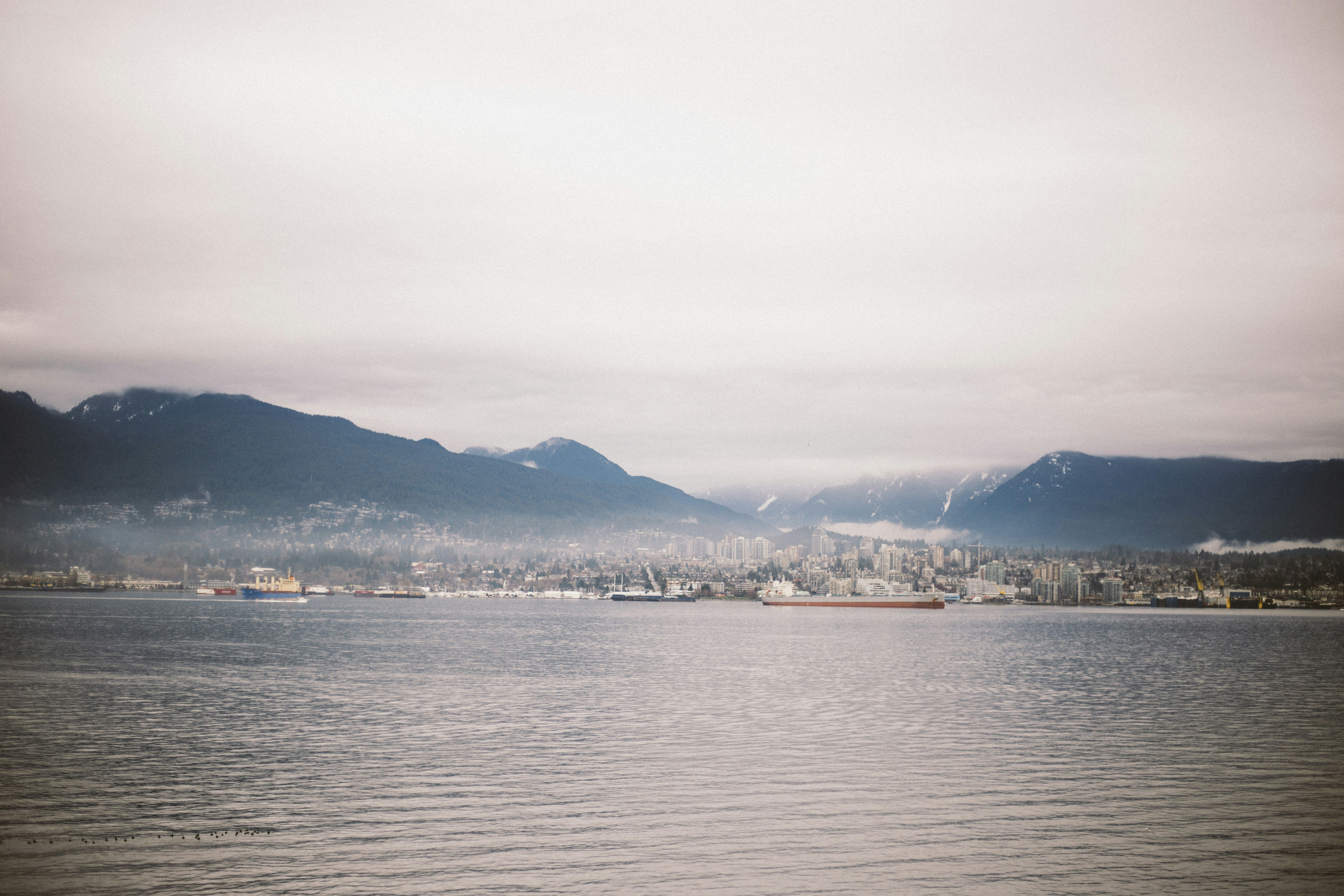 a large body of water with mountains in the background