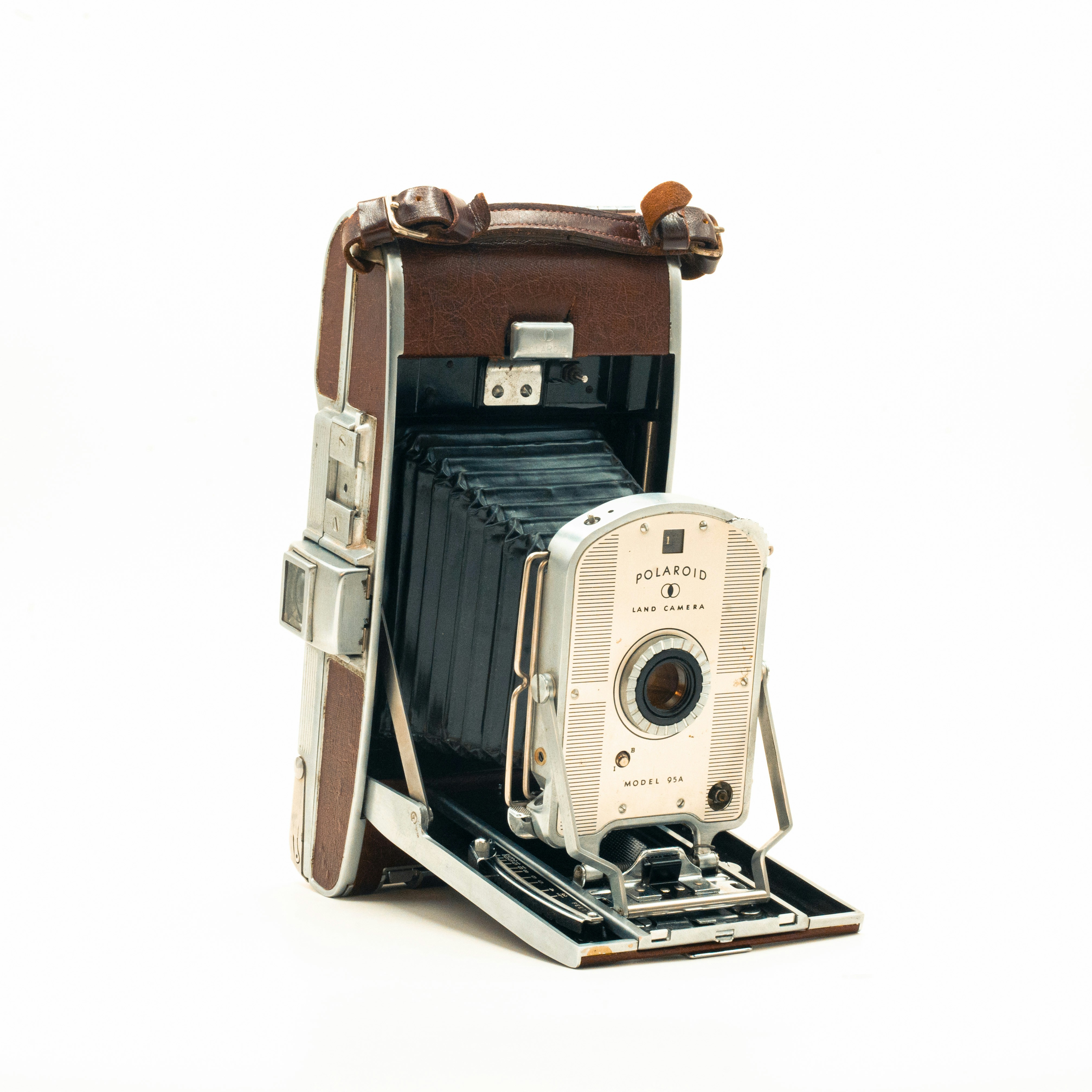an old fashioned camera sitting on top of a wooden box